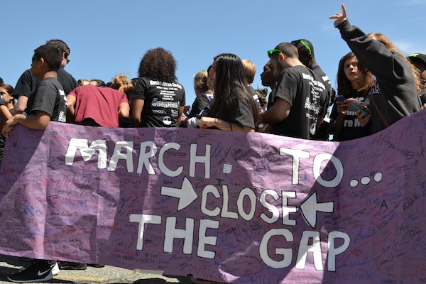 Identity Youth Holding Mach to Close the Gap Banner